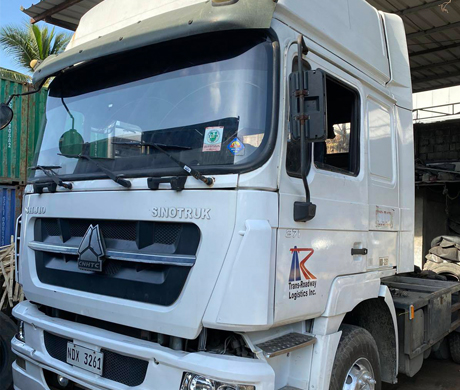 adult repairman holding screwdriver and using digital tablet while repairing washing machine in
