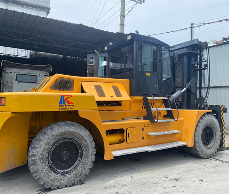 adult repairman holding screwdriver and using digital tablet while repairing washing machine in