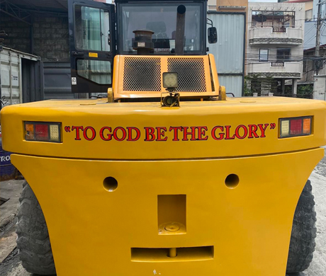 adult repairman holding screwdriver and using digital tablet while repairing washing machine in