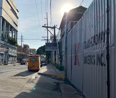 adult repairman holding screwdriver and using digital tablet while repairing washing machine in