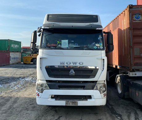 adult repairman holding screwdriver and using digital tablet while repairing washing machine in