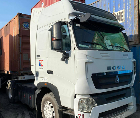 adult repairman holding screwdriver and using digital tablet while repairing washing machine in