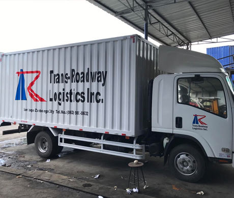 adult repairman holding screwdriver and using digital tablet while repairing washing machine in