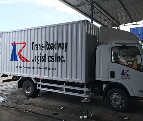 adult repairman holding screwdriver and using digital tablet while repairing washing machine in