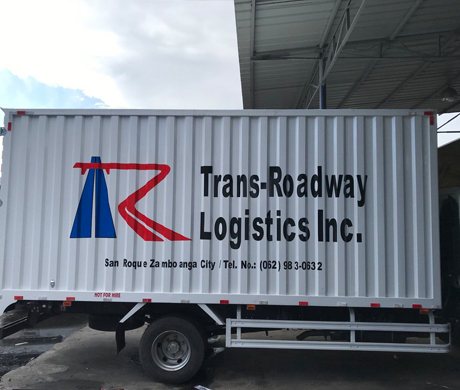 adult repairman holding screwdriver and using digital tablet while repairing washing machine in